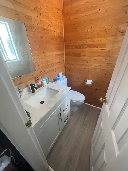a bathroom with white sink counter and toilet