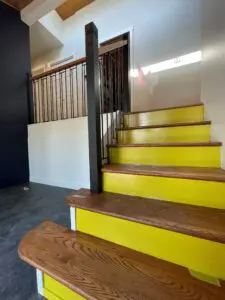 A picture of stairs with yellow paint